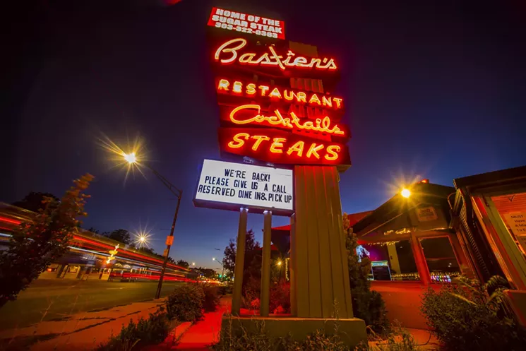 a neon restaurant sign outside a building