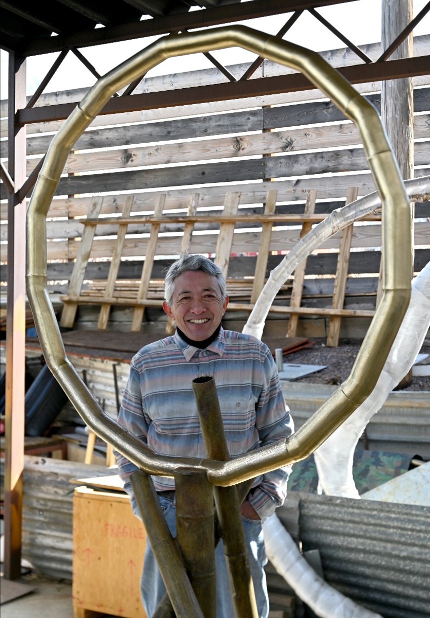 Yoshitomo Saito with his bamboo sculpture for the outdoor exhibition LandMark. - YOSHITOMO SAITO