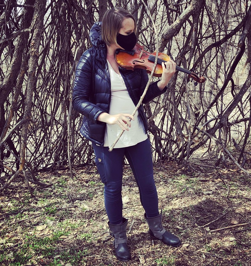 Playground Ensemble violinist Sarah Whitnah tests a tree-limb bow. - COURTESY OF CONTROL GROUP PRODUCTIONS