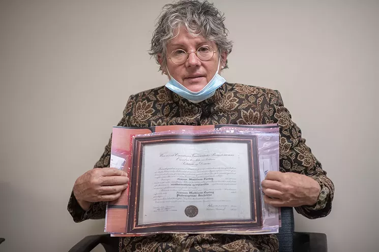 Julia Turing at the U.S. Customs and Border Protection office on May 25 with a copy of Alan Turing's Ph.D. diploma. - EVAN SEMÓN