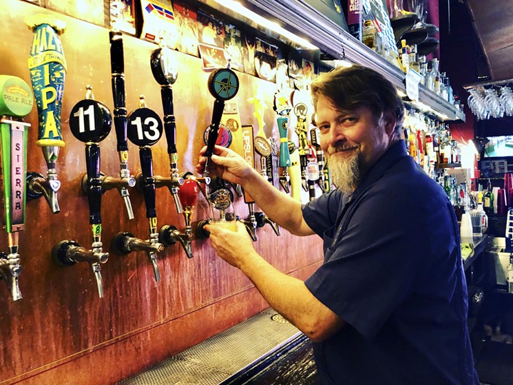 Chris Black pours a beer at Falling Rock Tap House. - JONATHAN SHIKES