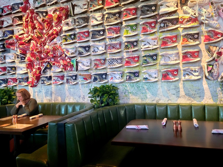 An artsy wall of Converse shoes. - LINNEA COVINGTON