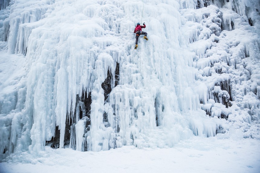 a man climbing a wall of ice