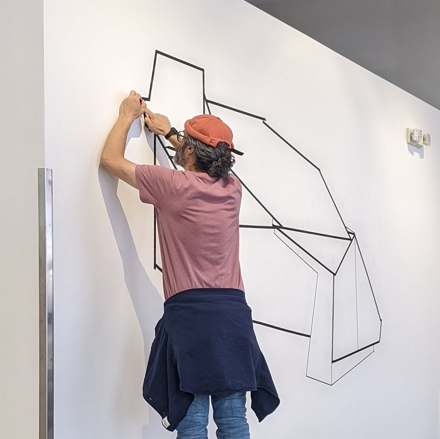 Artist Ramón Bonilla begins his wrap-around tape mural at Alto Gallery. - RAMÓN BONILLA