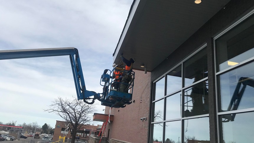 A construction worker getting elevated outside the Table Mesa King Soopers on January 12. - PHOTO BY MICHAEL ROBERTS