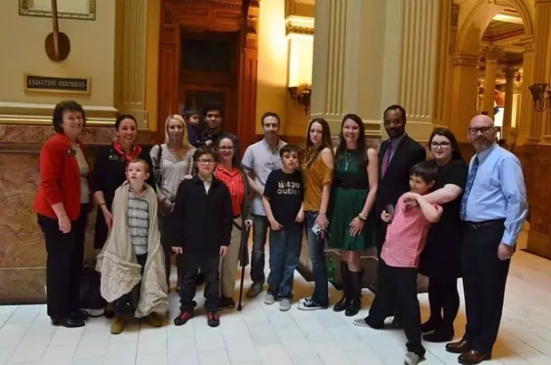 Autumn Brooks (middle row, fourth from left) and Michelle Walker (second from right) pose with their sons for a group photo at the State Capitol in 2019. - MELANIE ROSE RODGERS
