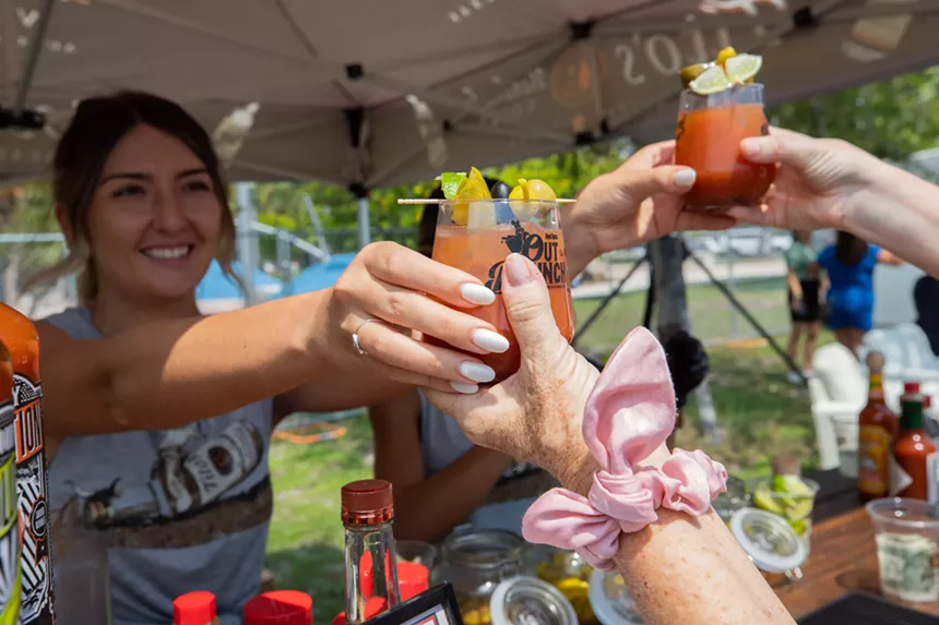 woman handing bloody marys to someone