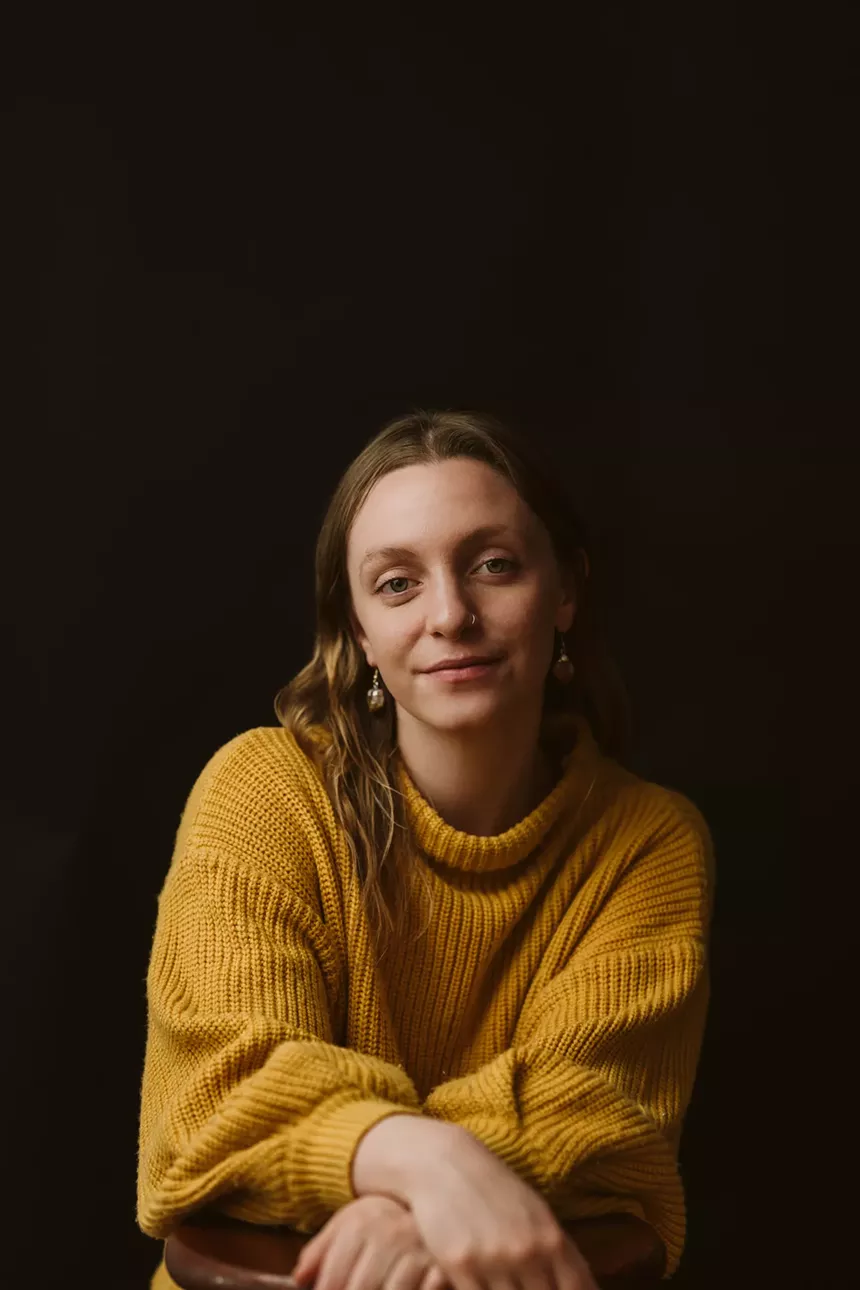 blonde woman in yellow sweater