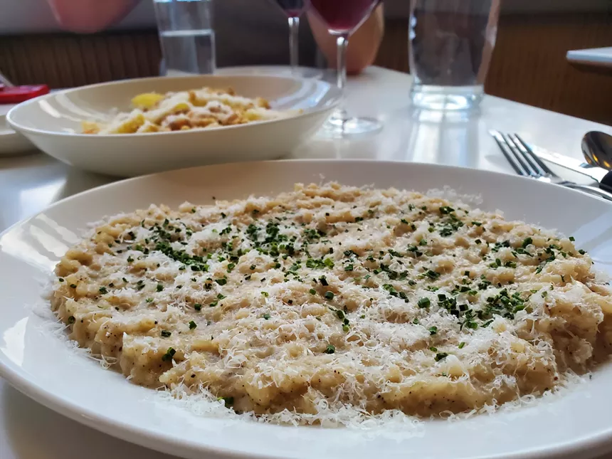 a plate of risotto on a table.