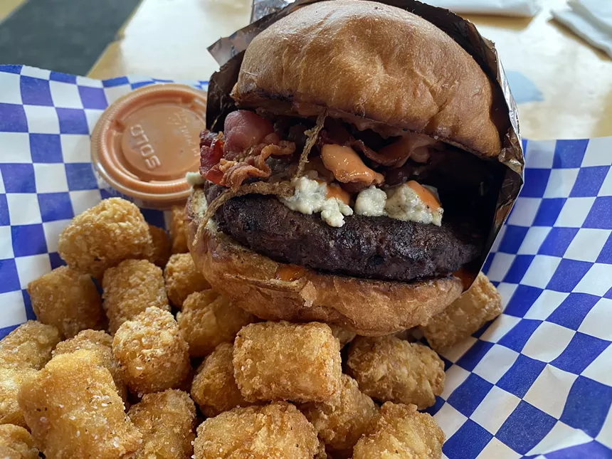 a blue cheese burger with tots