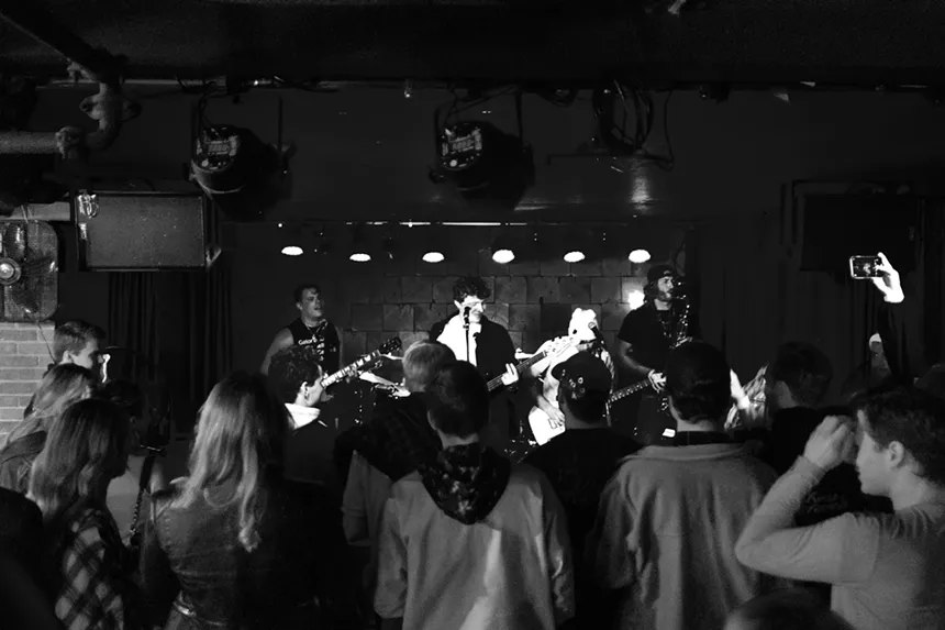 a band plays in front of a crowd