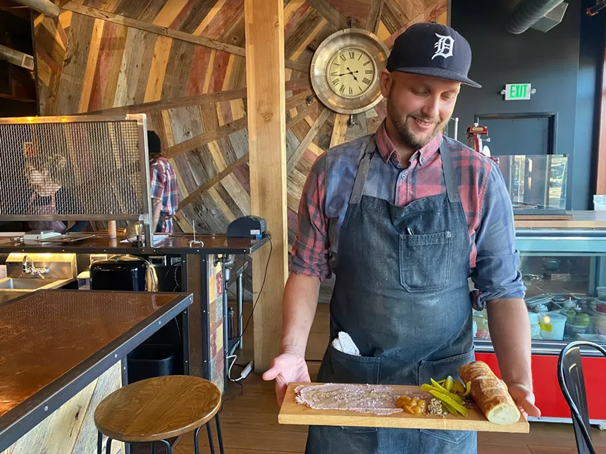Man holding cheese board