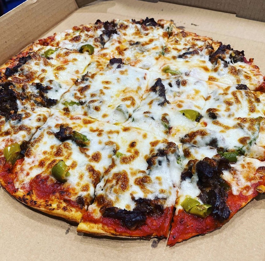 a cheese-covered pizza in a an open box