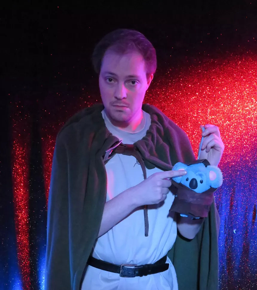 man in brown cloak holding stuffed animal