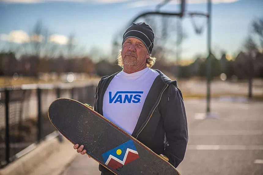 Recreation advocate Dave Riordon speaking and holding a skateboard in Denver, Colorado.