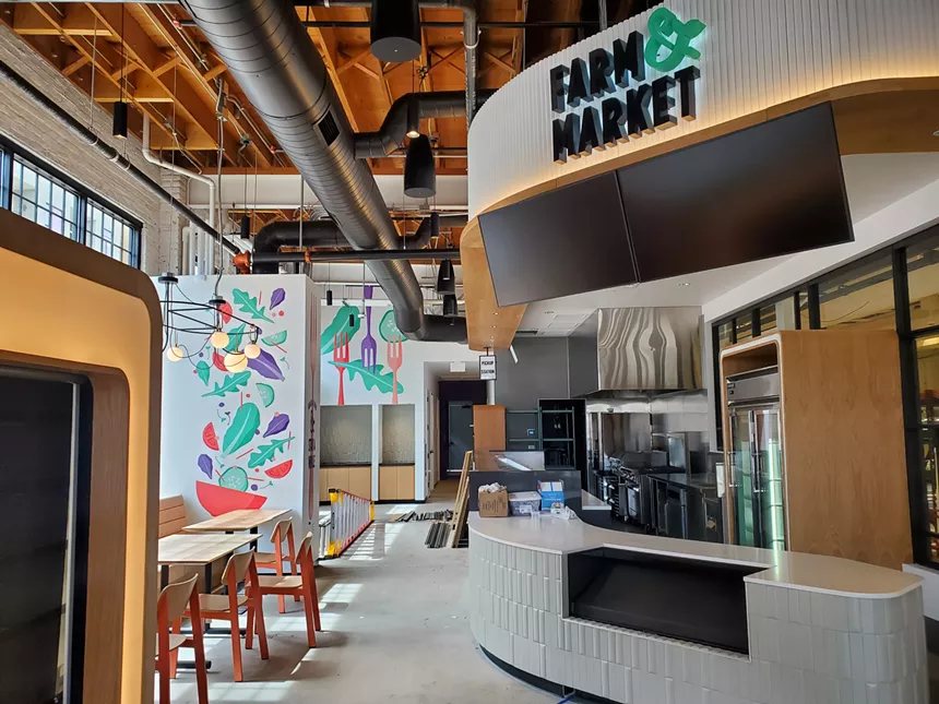 the interior of a building with a fast casual restaurant counter