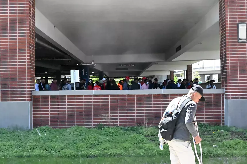 A group of migrants waiting at the 5th Street Garage on the Auraria Campus in Denver, Colorado.