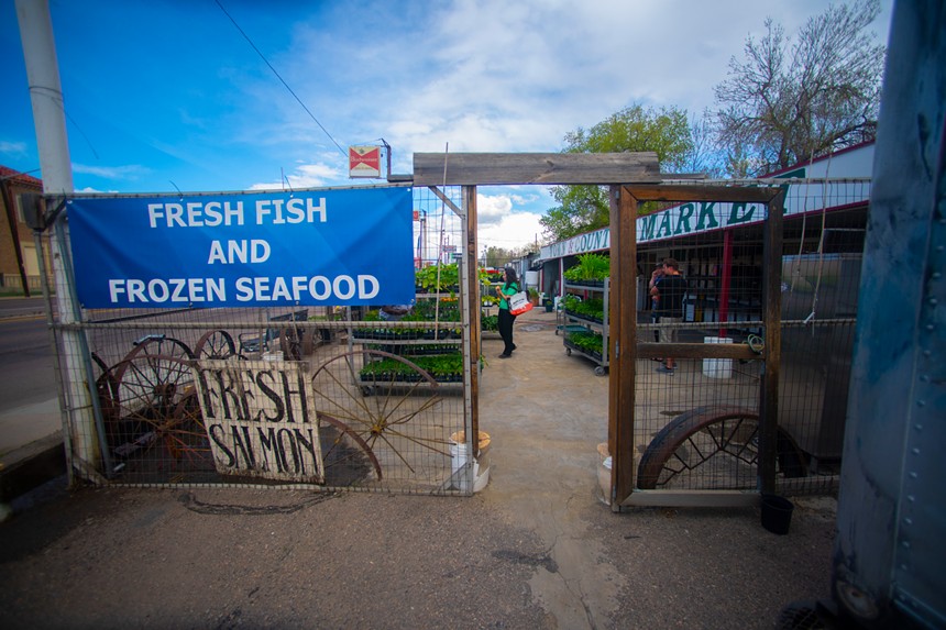 the entrance of a store with a big blue sign advertising fresh seafood