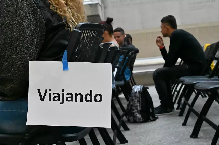 People gathered inside the emergency migrant intake center in Denver, Colorado.