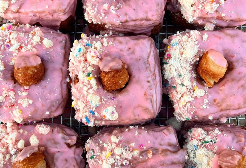 square doughnuts with bright pink frosting