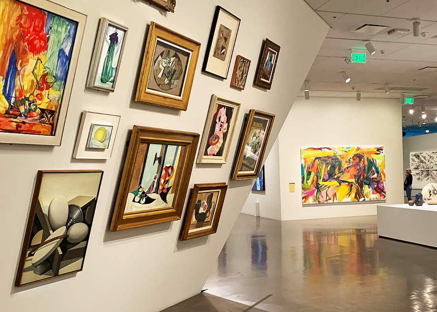 paintings hang on a slanted wall