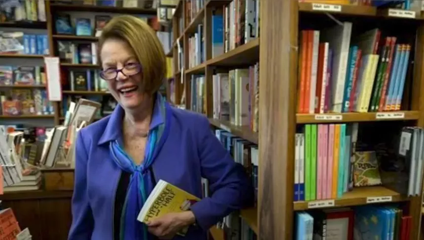 woman in front of bookshelf