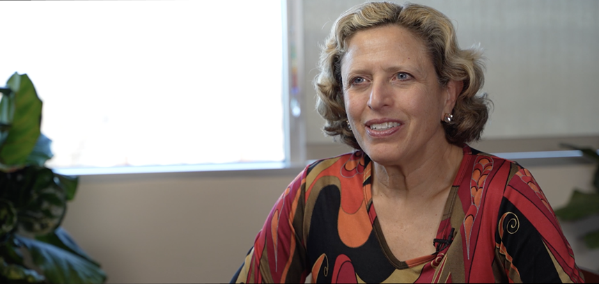 a woman in a patterned shirt