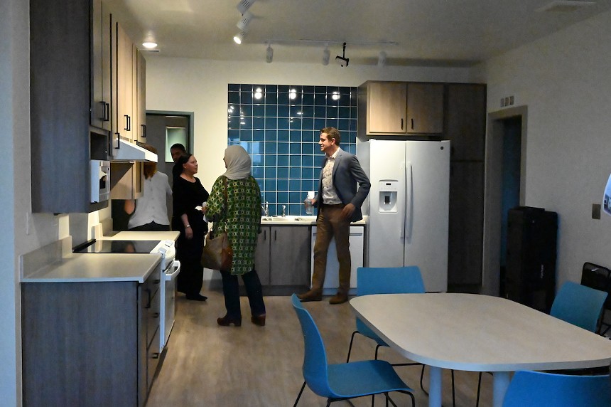 Miles Gonzalez, an area manager for Brothers Redevelopment, showing curious visitors what the three-bedroom units look like at Valor on the Fax in Denver, Colorado.