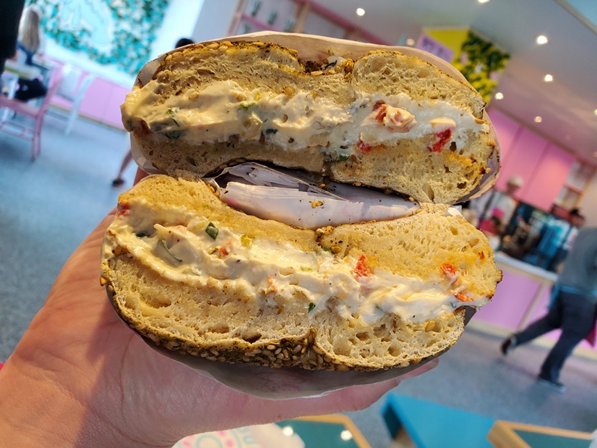 a bagel with cream cheese cut in half