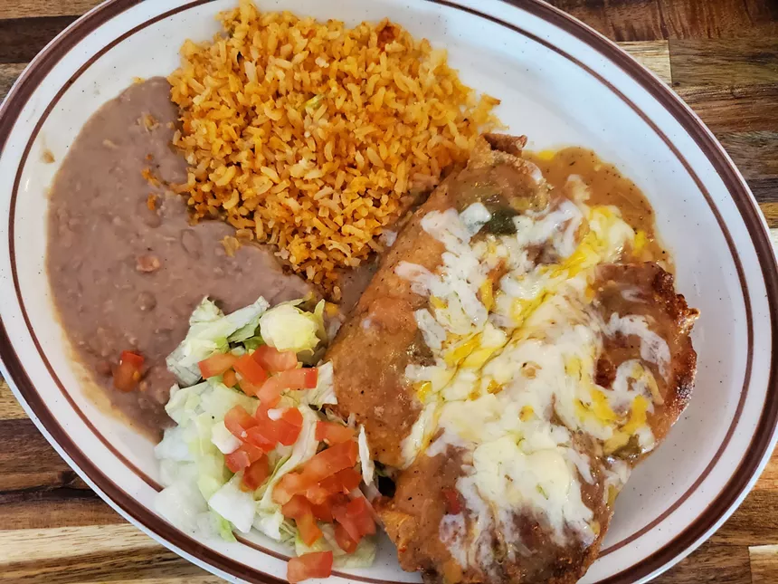 cheese-covered chile rellenos with rice and beans