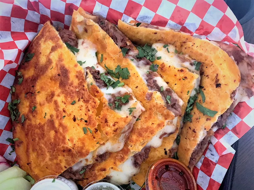 quesadillas on red and white checkered parchment paper