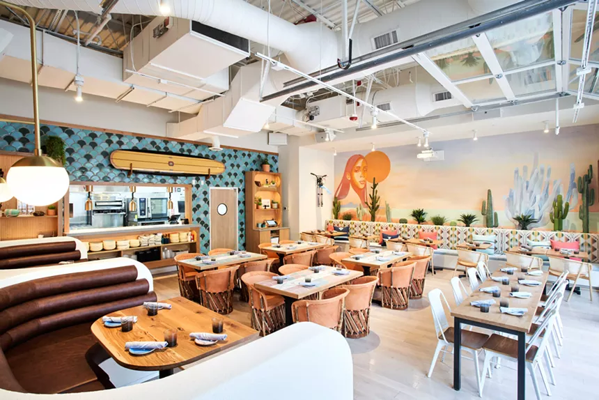 the interior of a restaurant with coastal decor