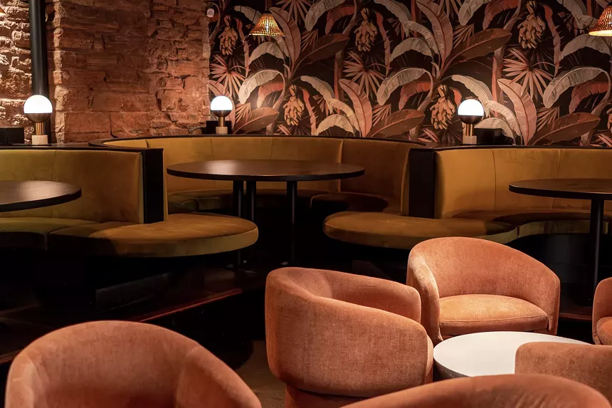 A cocktail lounge with tropical wallpaper