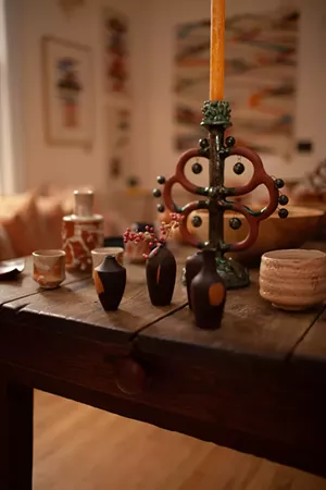 handmade glassware and pottery positioned on a wooden table