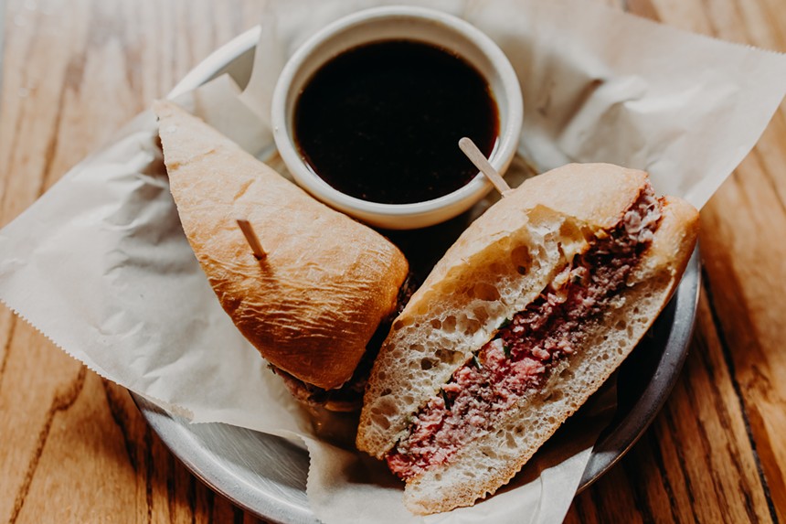 a french dip sandwich with jus on the side