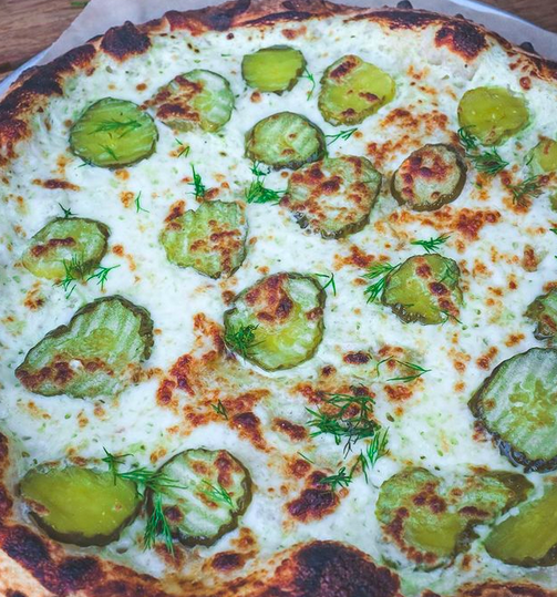 a pizza topped with pickles