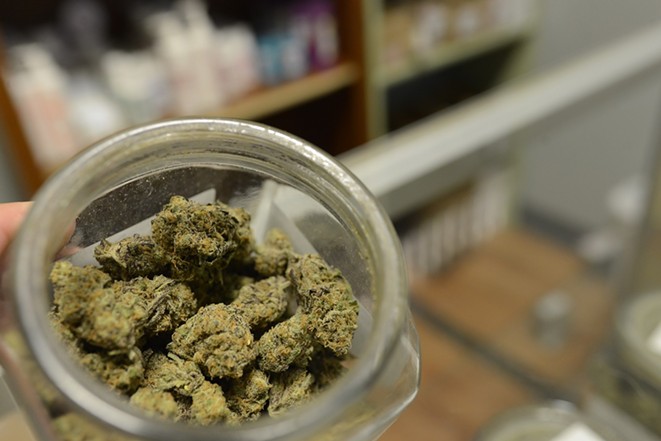 An open jar of cannabis inside of a dispensary