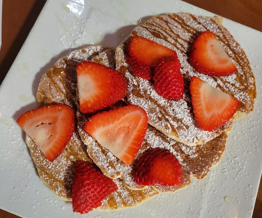 three pancakes topped with strawberries