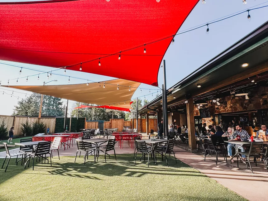 red awning over an outdoor space with tables