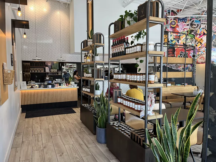 products on shelves in front of an ordering counter at a restaurant