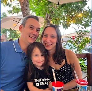 Adam and Hannah Rossi with their daughter.