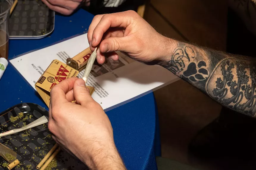 A man rolls a joint of cannabis
