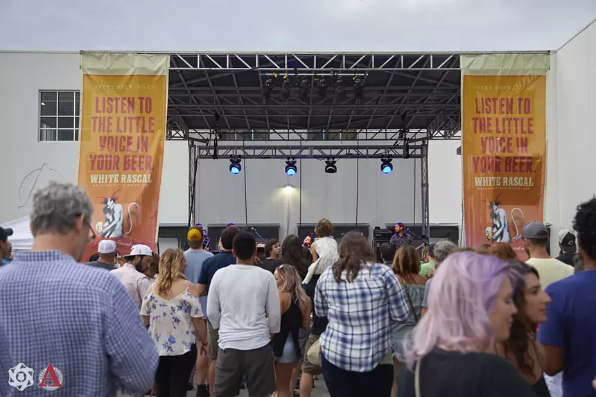 people standing in front of a stage