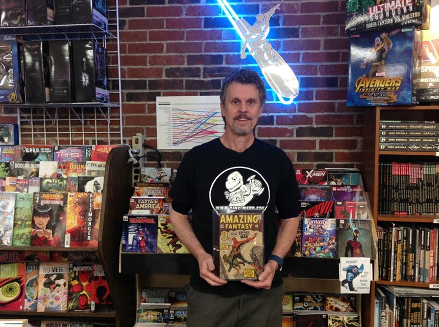 man standing in comic store.