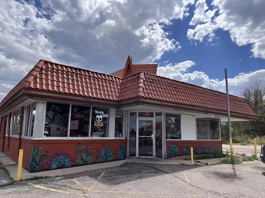 the outside of a bulding with a brown roof