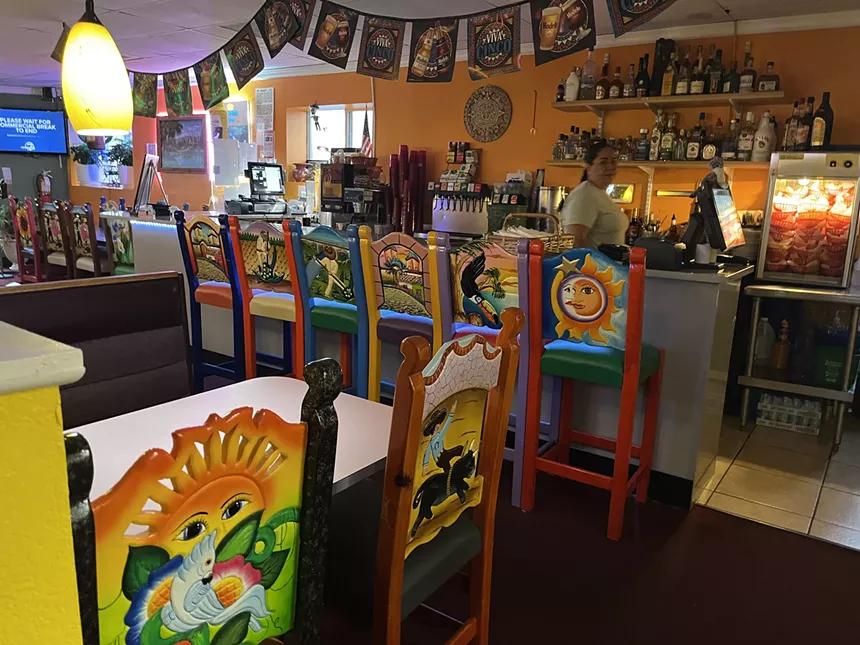 colorful chairs lining a bar