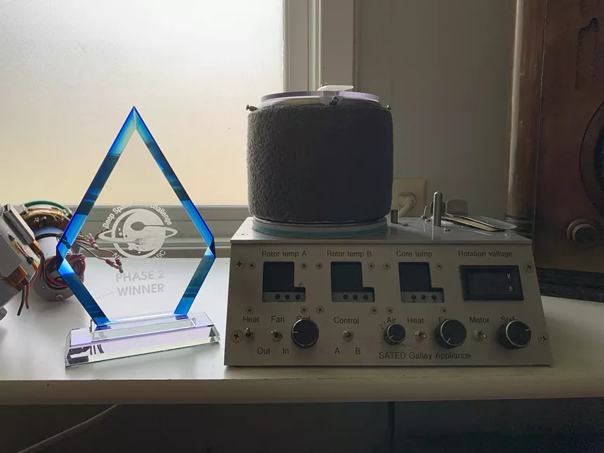 a diamind-shaped plaque next to a device with knobs