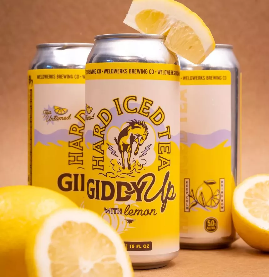 three cans with lemon slices around them