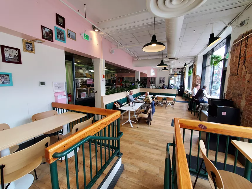 the inside of a restaurant with pink walls