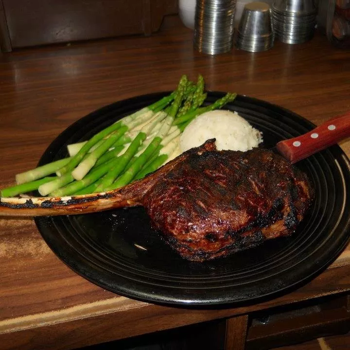 large steak on a plate with asparagus